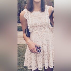 White lace mini dress with cross back